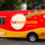 A colorful food truck printed with decals and designs by Printastik