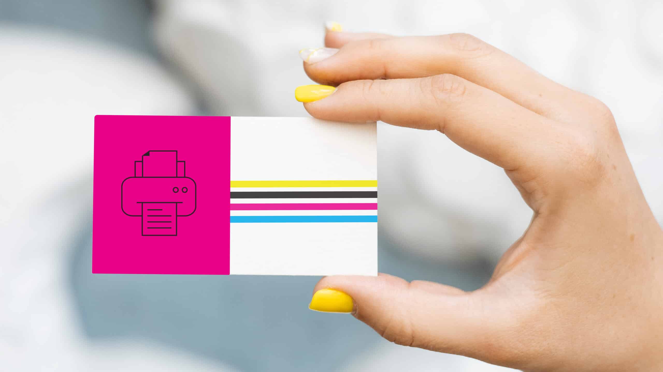 A hand holds a custom-made and printed Printastik-colored business card.